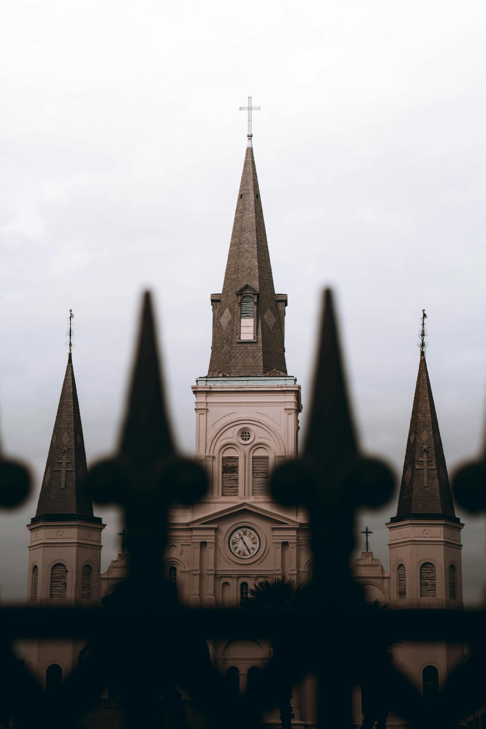 A dramatic view of St. Louis Cathedral's iconic spires in New Orleans.